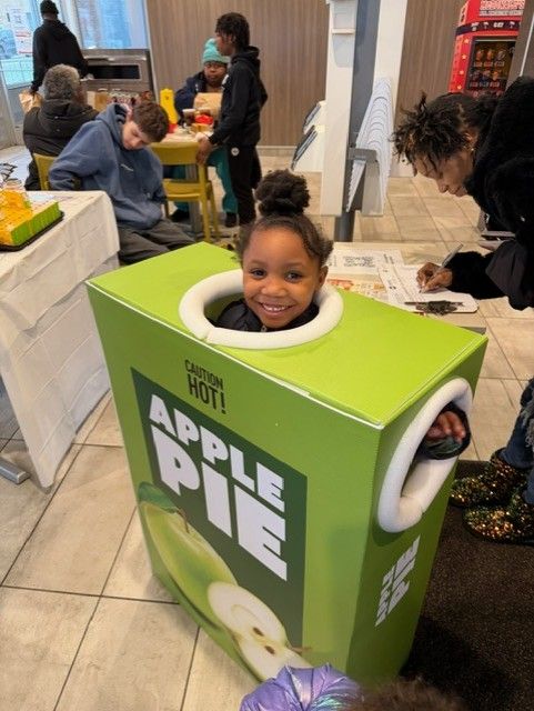 A student wearing the apple pie costume at McTeacher Night