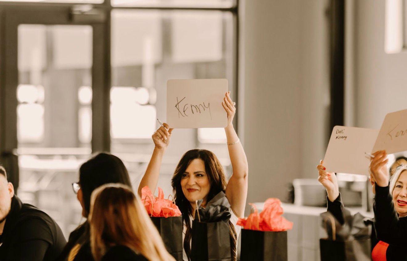 A Northstar leader smiling and holding up a name sign during a summit game