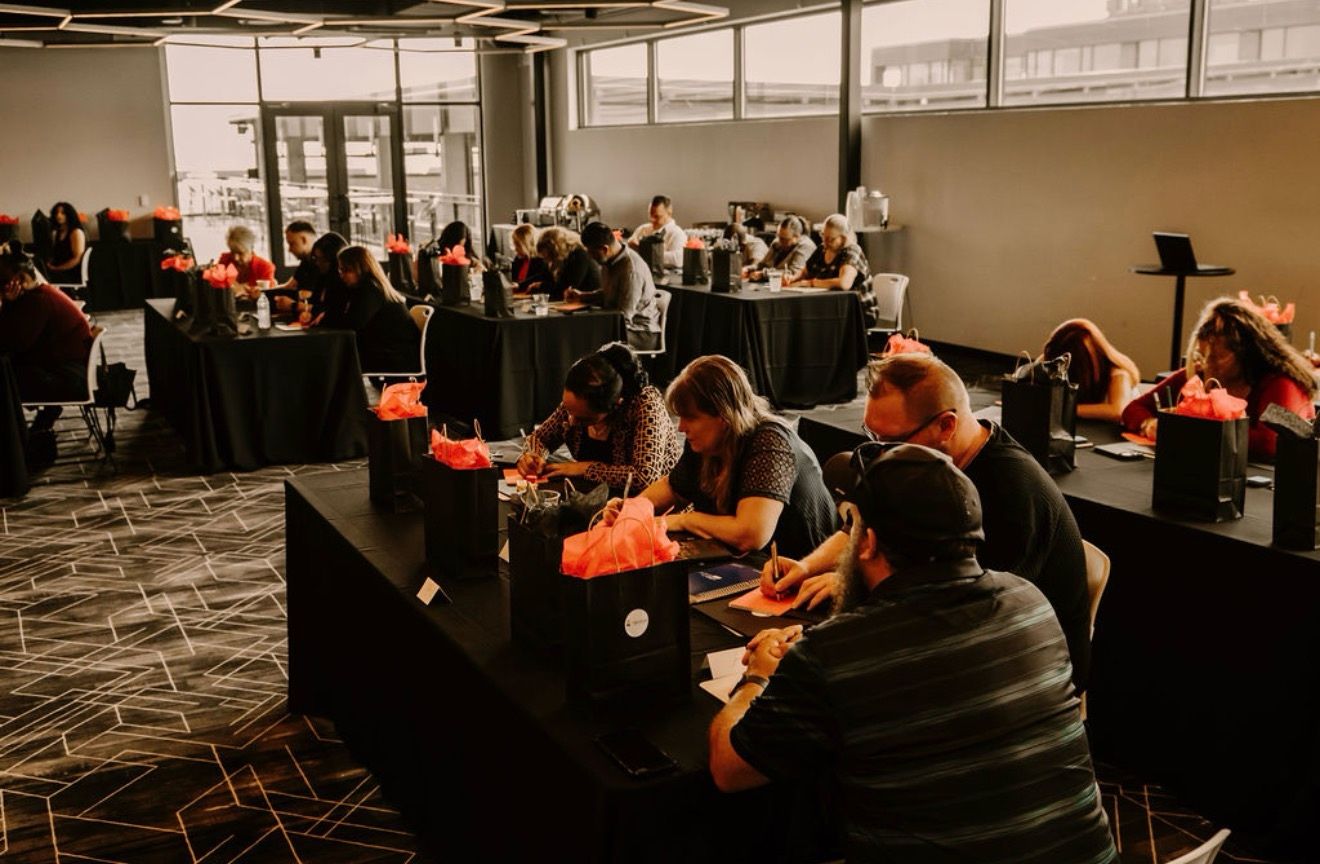 The room at work — leaders writing at their tables