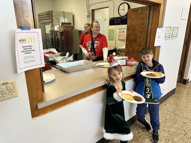 Volunteers serving breakfast at the school