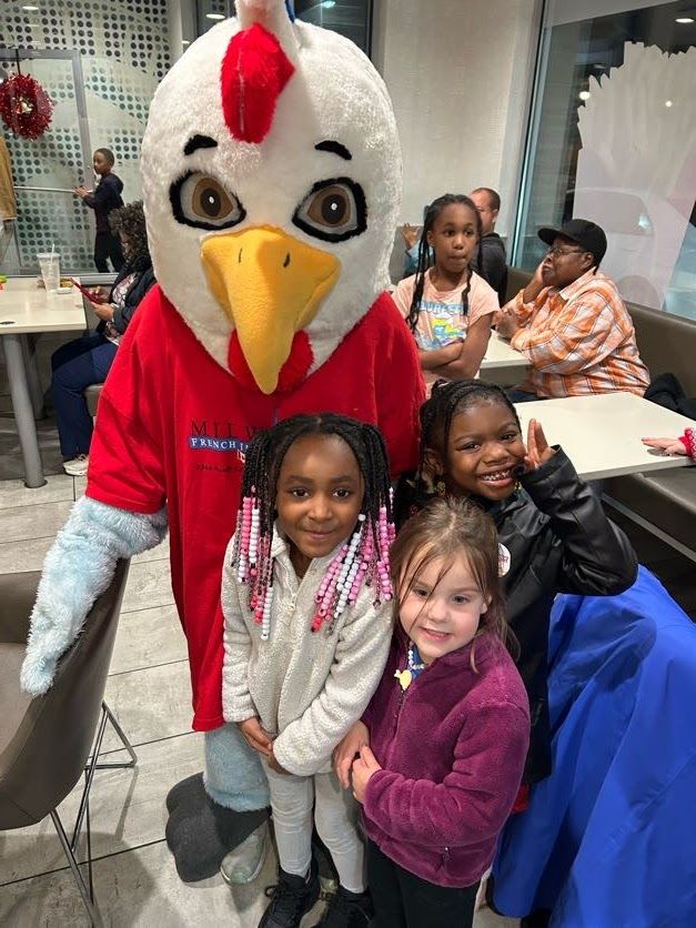 The school mascot with students