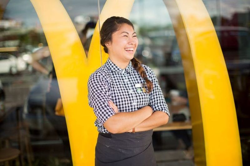A crew member smiling beneath the golden arches